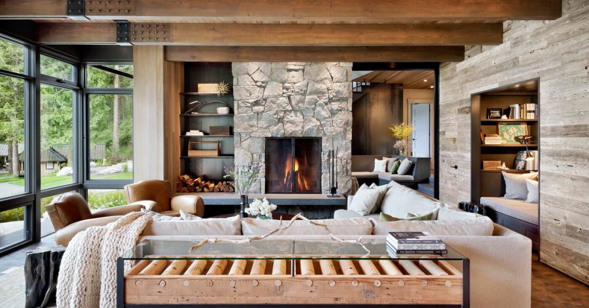 rustic ocean home large living room with stone fireplace and large windows