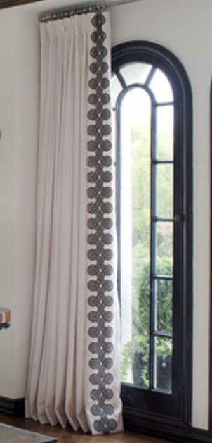 Single panel white curtain with black tape trim at leading edge