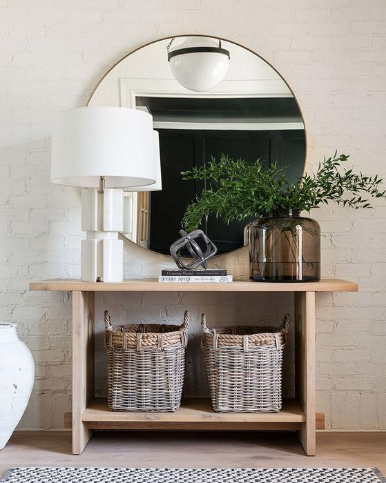 light-wood entryway table with elegant minimalism circular brass mirror