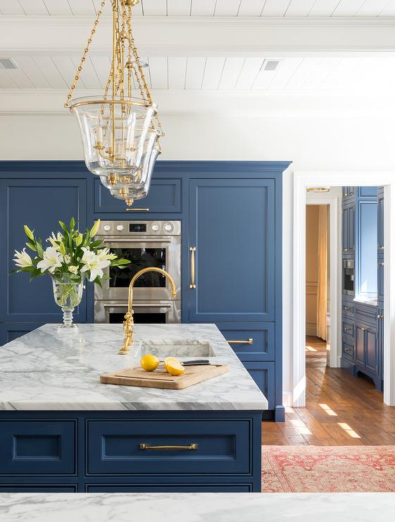 blue-kitchen-with-glass-and-gold-bell-jar-island-lanterns