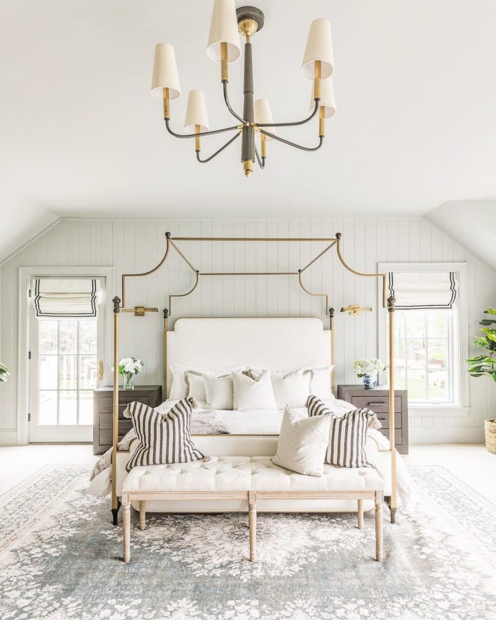 elegant white bedroom with gold iron canopy bed