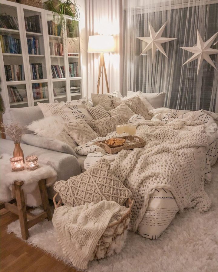 cozy hygge interior design idea with white sofa and white blankets