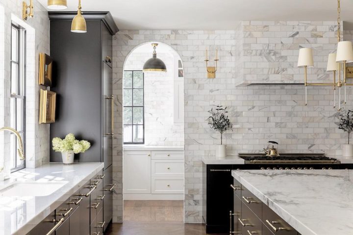 black kitchen with white marble countertop and white tiles