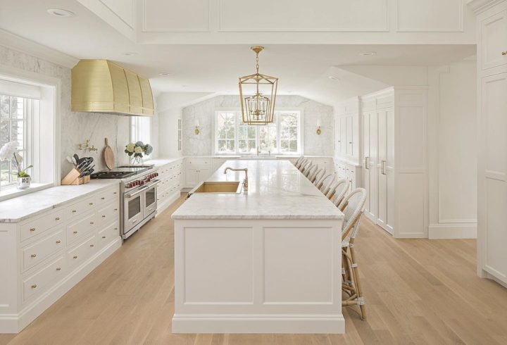 white and gold kitchen with large island