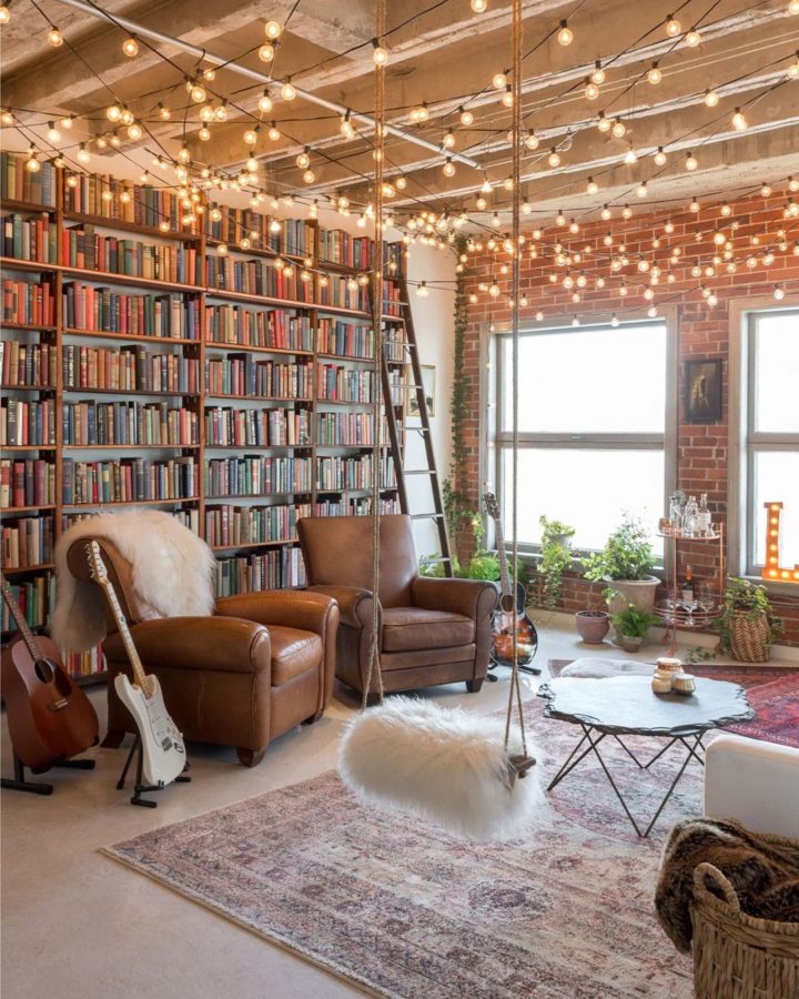 dream industrial loft with string lights, leather armchairs and library