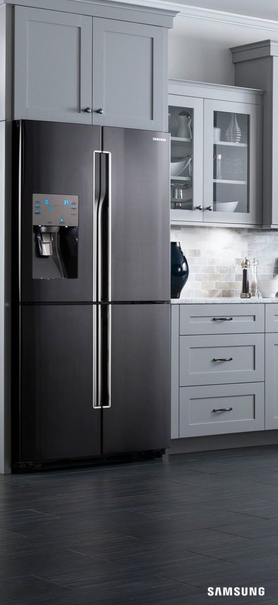 light grey kitchen with black refrigerator and black and black hardware