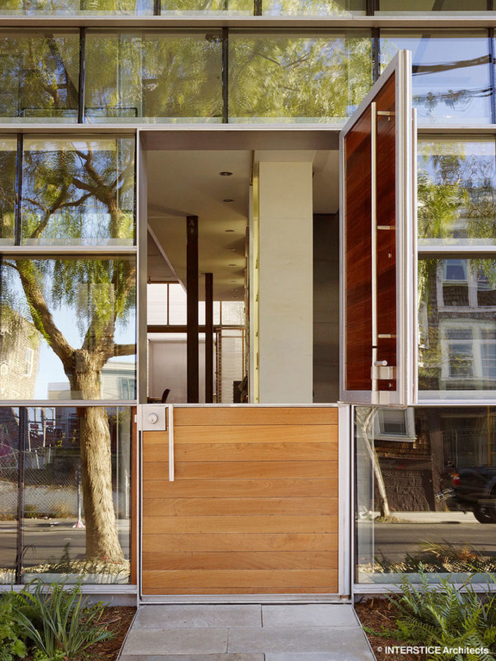  modern Dutch door surrounded by walls of windows