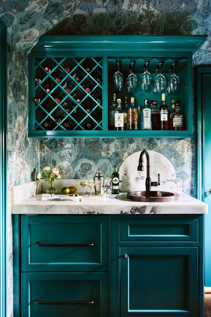 teal built in wet bar with wallpaper and  under-counter refrigerator