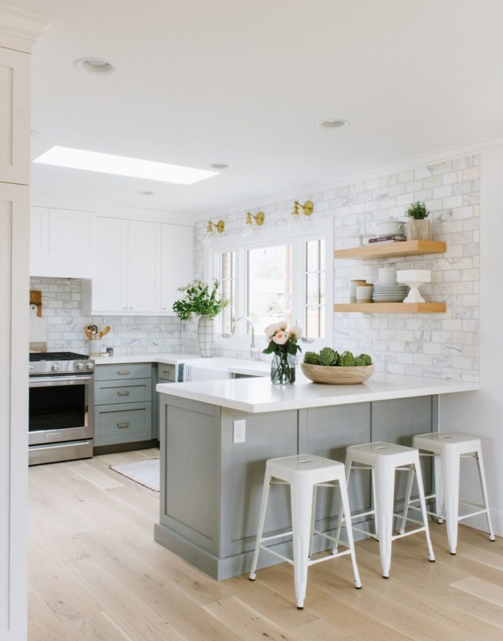 white gold and light grey kitchen with peninsula with seating