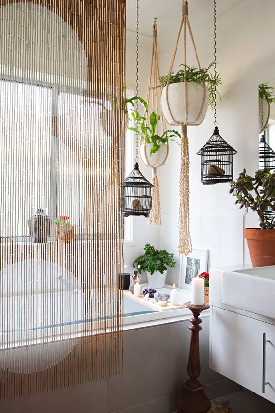 boho bathroom with crystals and candles to hanging bird cages and bamboo macrame curtains