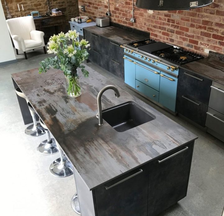 modern industrial dark gray kitchen with Dekton Countertop and brick wall