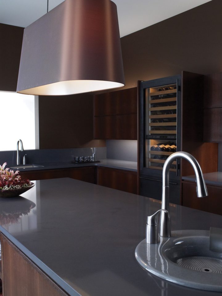 modern kitchen with dark wood cabinets and polished Gray Fieldstone Quartz