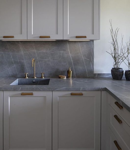 gray kitchen cabinets-with gold hardware and gray marble countertop