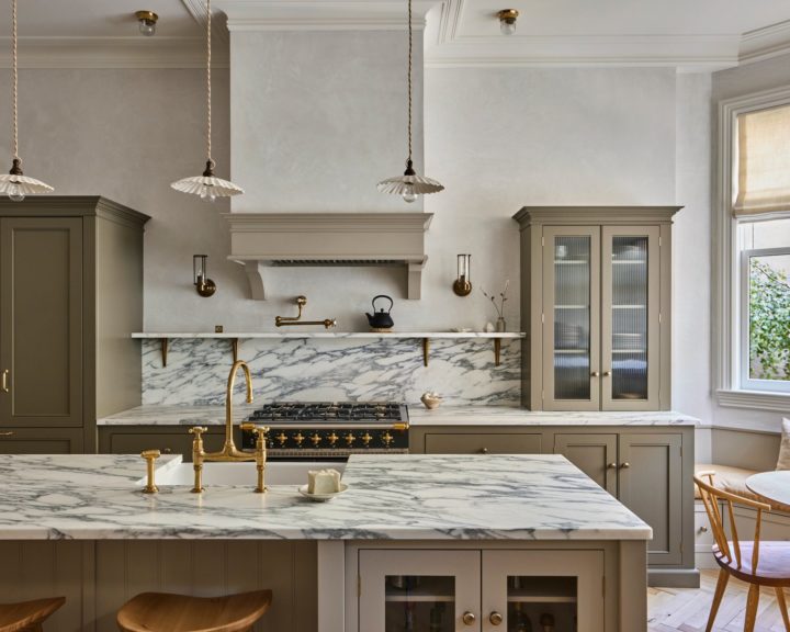 classic English style grey green kitchen with marble countertop and island with gold faucet