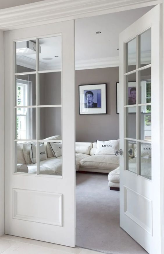 modern living room with white double french doors with with glass panes