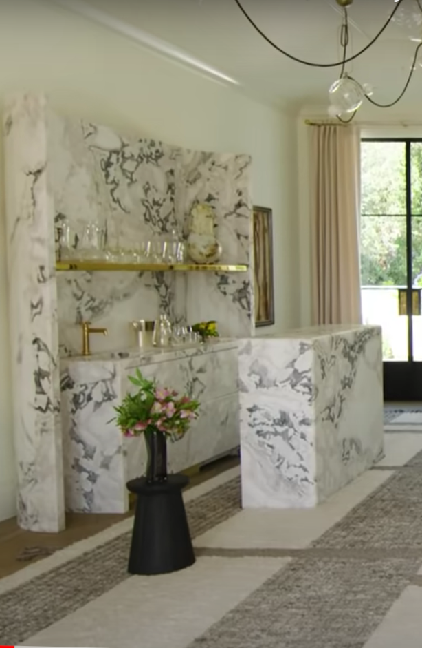 Gwyneth Paltrow's Exquisite Montecito Home white marble home bar with gold shelves