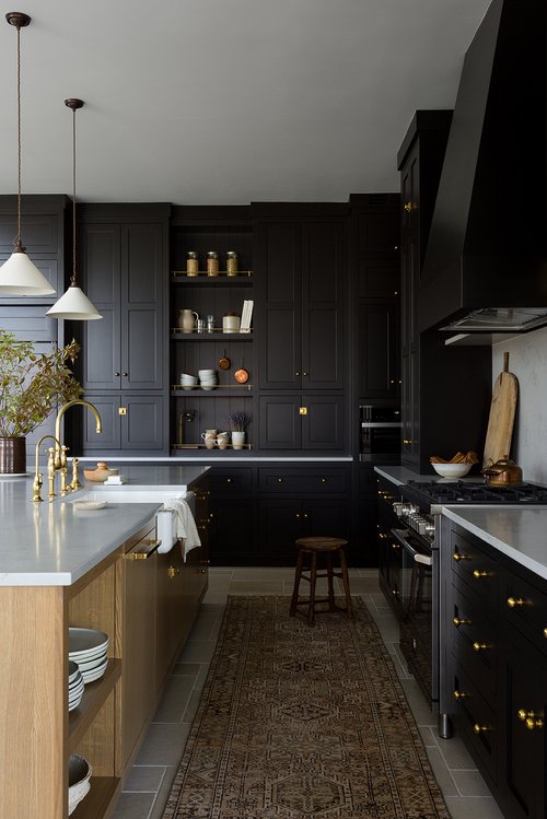Black Kitchen Cabinets with white worktop and light wood island