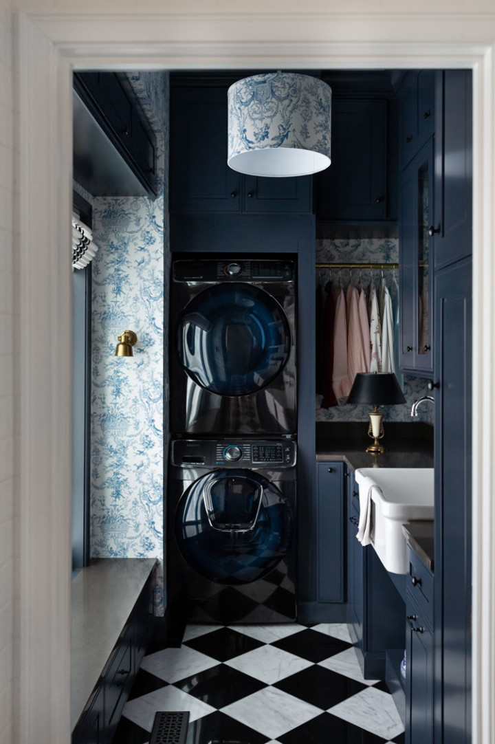 dark blue laundrey room with checkered floor and black washer and black washer and dryer set