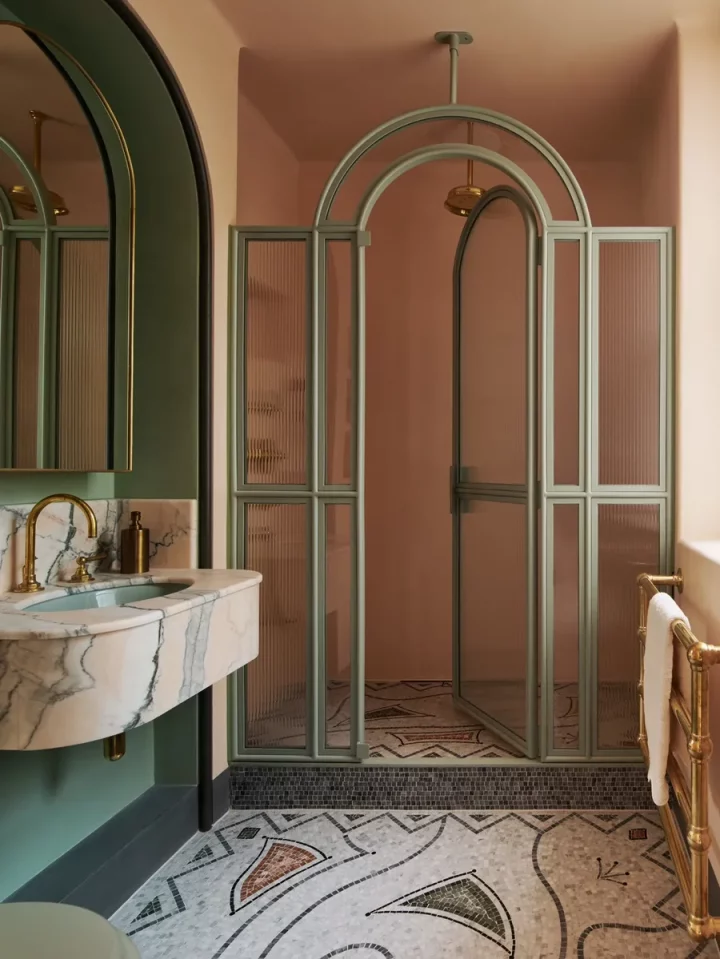green and pink bathroom  Jean Cocteau–inspired mosaic, the shower screen is custom, and the sink surround is Jordan Pink Portuguese marble