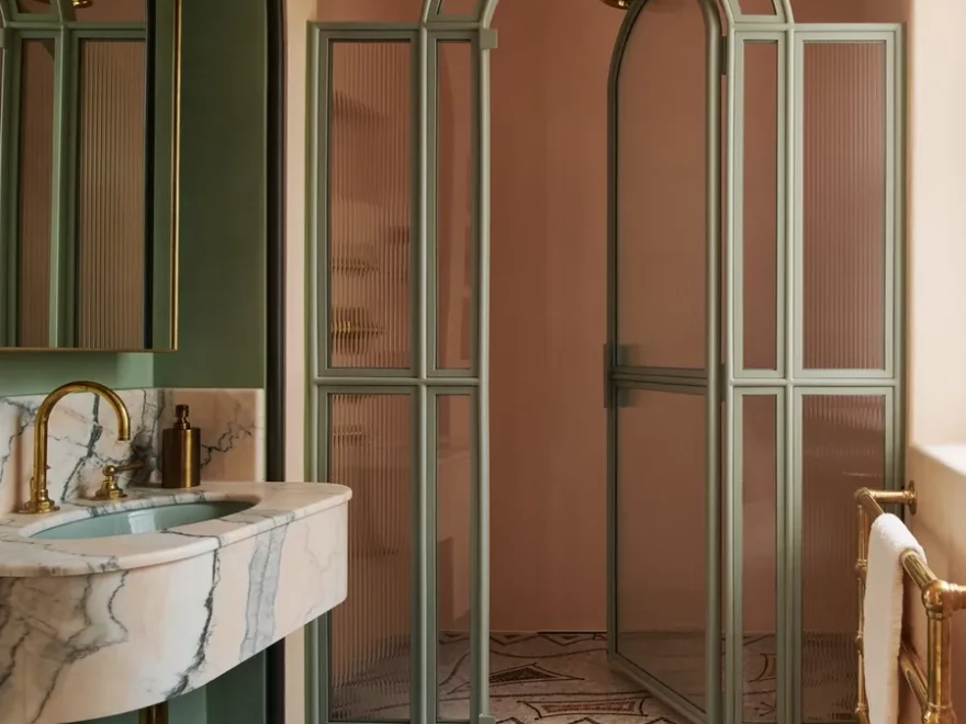 green and pink bathroom Jean Cocteau–inspired mosaic, the shower screen is custom, and the sink surround is Jordan Pink Portuguese marble