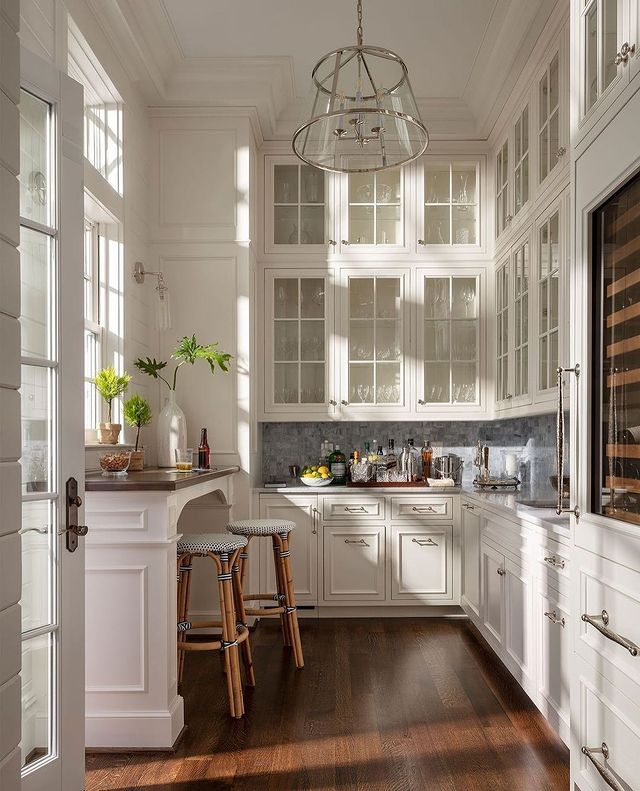 white cream colored kitchen with cabinets to high ceiling