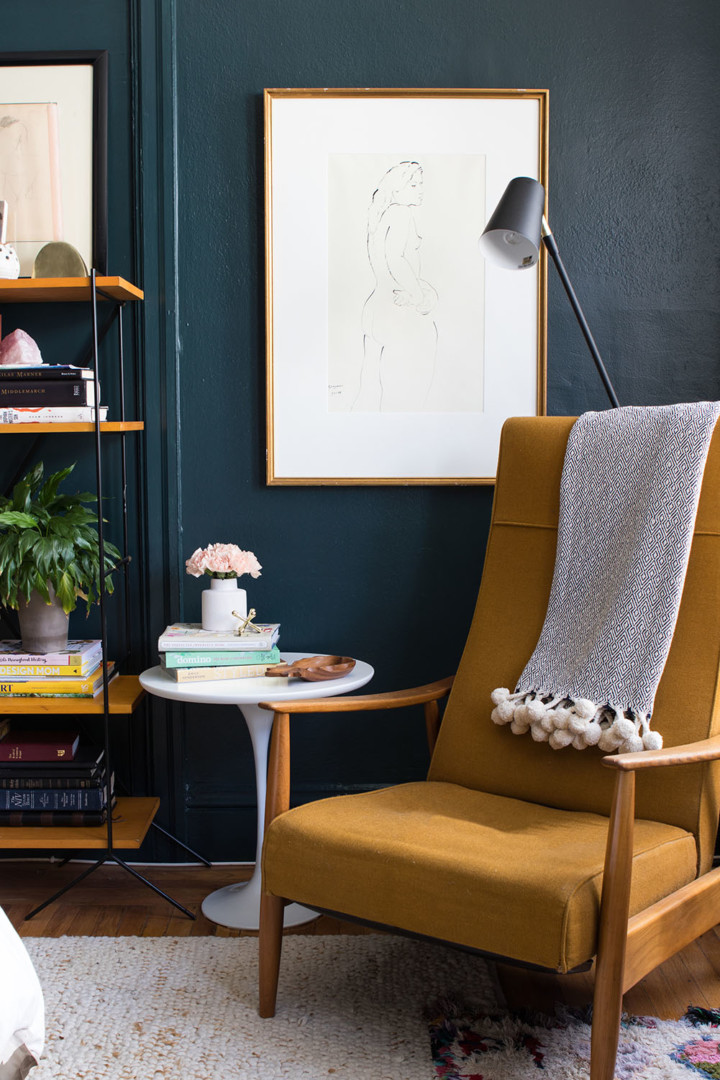 dark blue green wall paint with mustard armchair