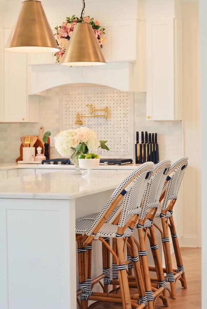 White kitchen remodel with gold cone pendants and riviera stools
