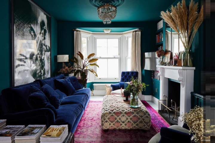 living-room-with-dark-green-walls-and-navy-velvet-sofa