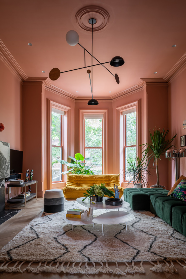 strong terra cotta pink modern colorful living room wiyh bay windows
