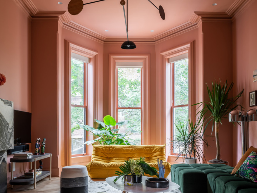 strong terra cotta pink modern colorful living room wiyh bay windows