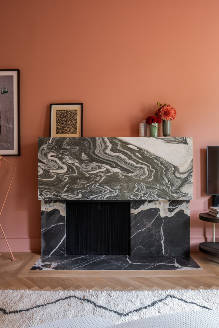 strong terra cotta pink  Benjamin Moore Palazzo pink  wall paint and cusyom black and white marble fireplace mantel