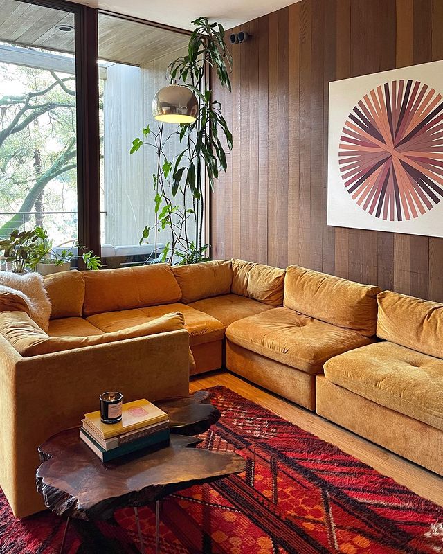 mid century modern living room with yellow sectional sofa and wood panelling
