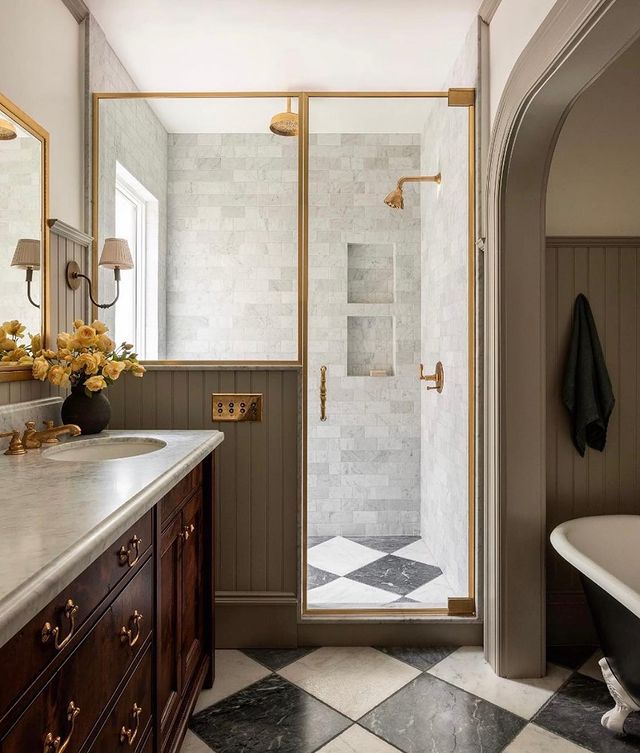 bathroom with black and white floor and gold hardware