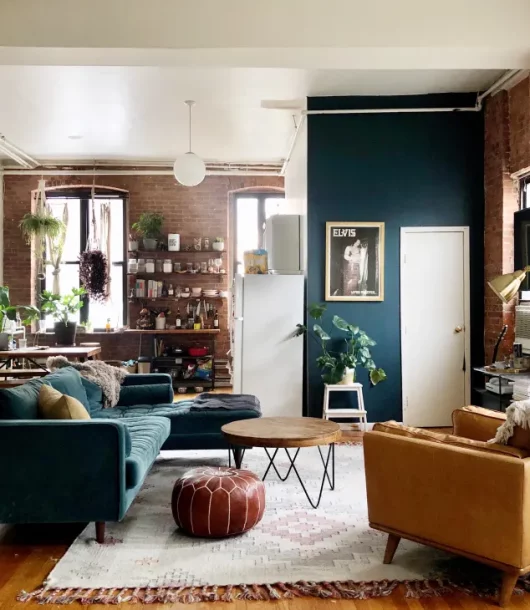 Industrial living room on a budget with brick walls blue sofa and yellow armchair
