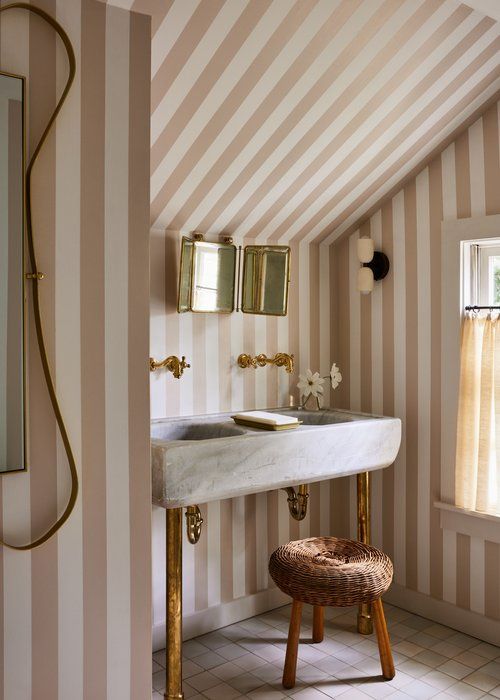 attic bathroom cream & white designer stripe wallpaper and small gold tri-fold barber mirror