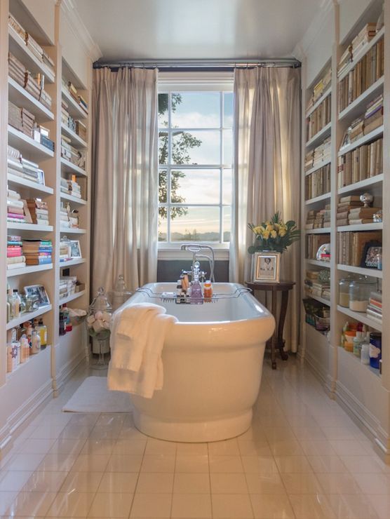 bathroom with freestanding tub and  bookshelves