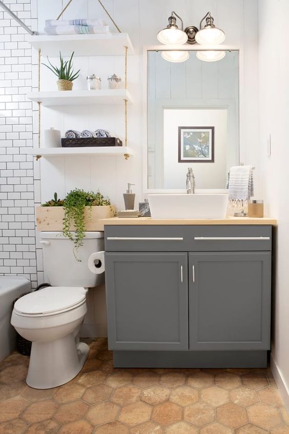 bathroom with hanfing over the toilet shelves