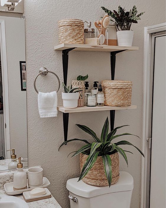 tiny bathroom with wood and black over the toilet shelves
