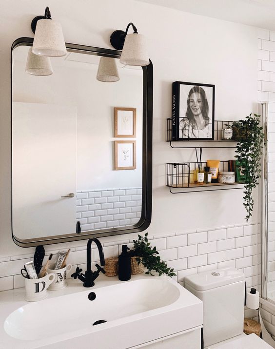 black and white bathroom with industrial over the toilet shelves