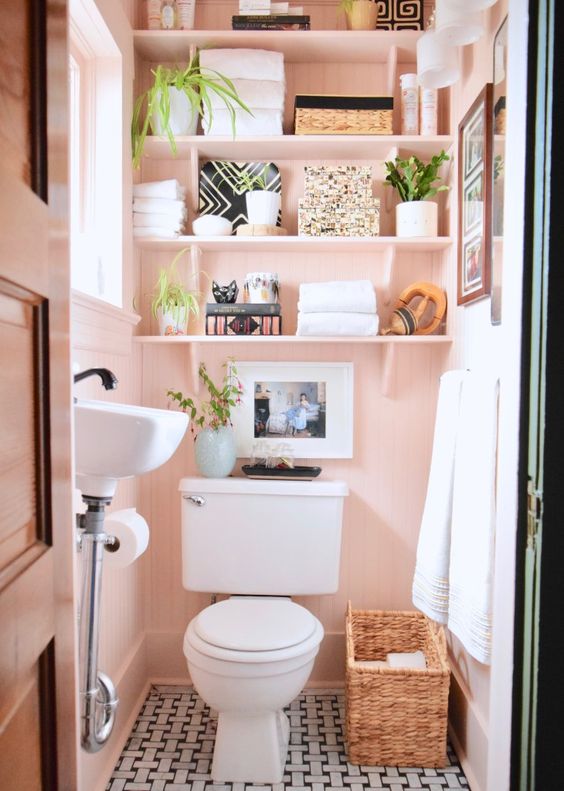 tiny pink bathroom with  Over the toilet shelves