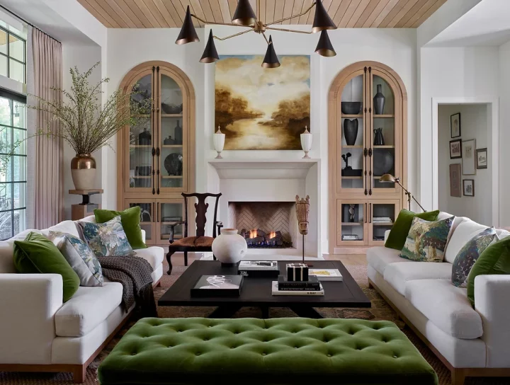 neutral living room with  green velvet tufted ottoman and pillows