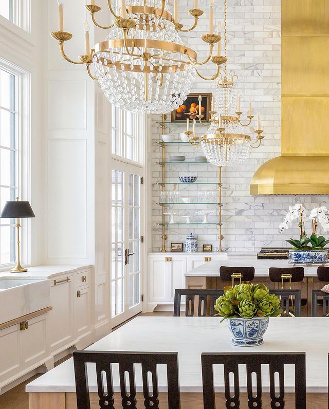 luxury kitchen design with chandeliers and gold hood