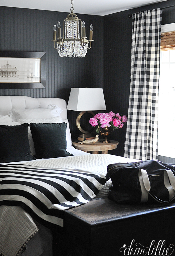 dramatic guest room with black and white plaid curtains