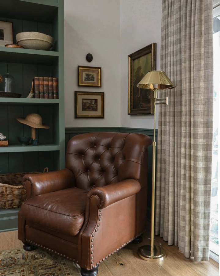 family room with brown leather tufted armchair and brown beige plaid curtains