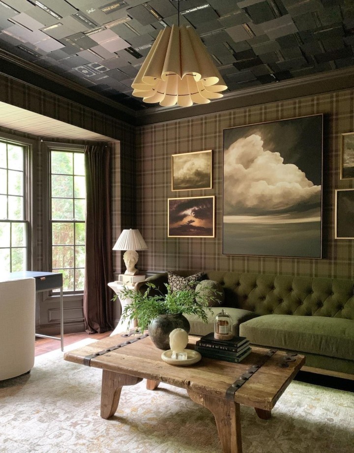 living room home office with brown plaid wallparer wall art gallery and green velvet tufted sofa