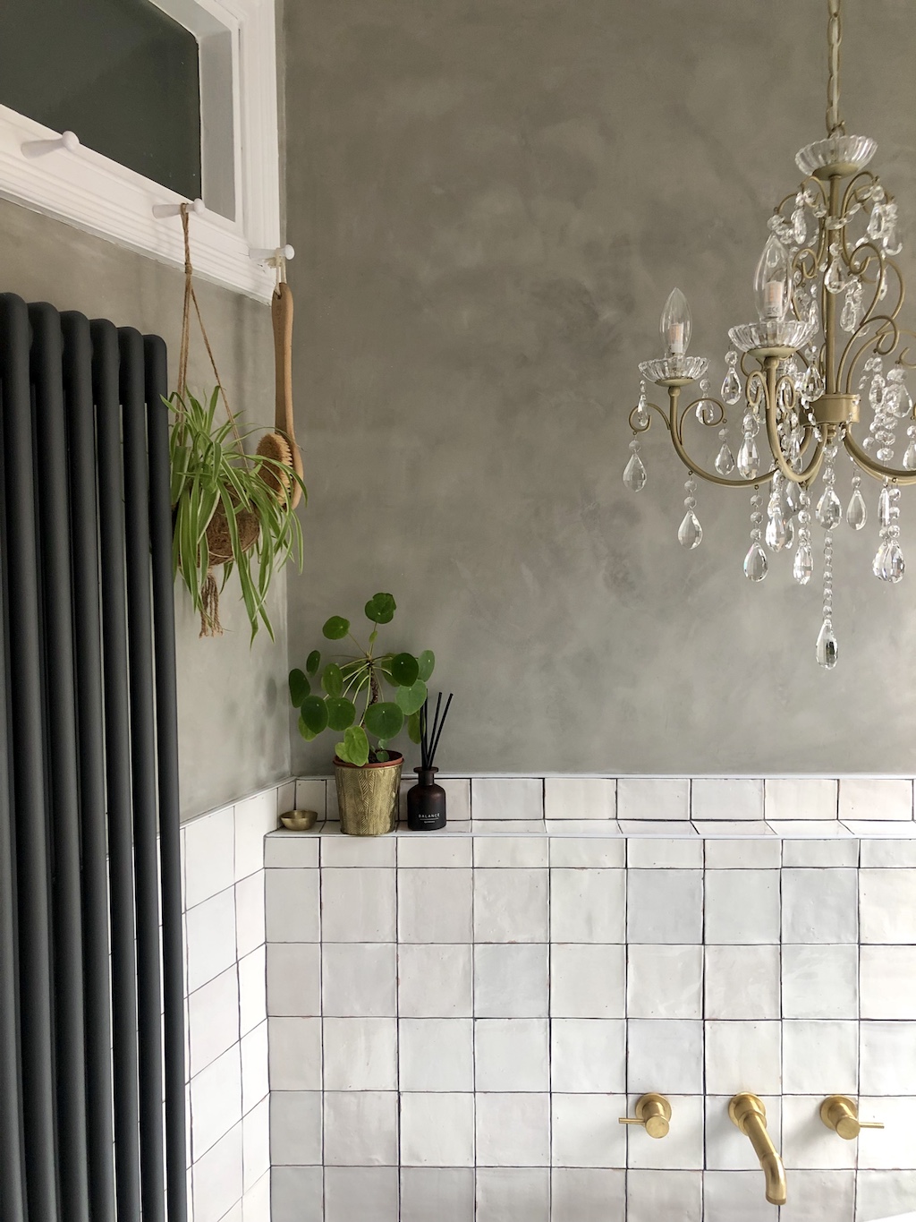 bathroom with square subway white tiles half way and then grey concrete on the top half