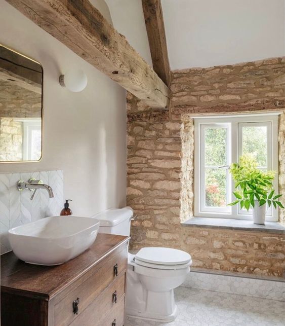 modern stone wood farmhouse style bathroom with recaicled wood beams