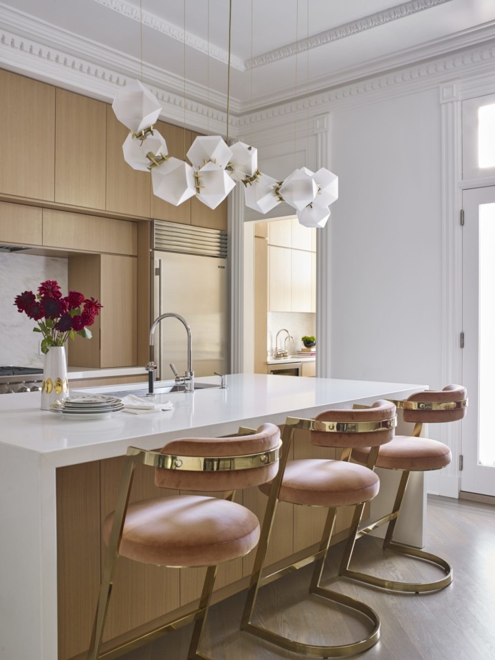 wood kitchen with pink and gold stools