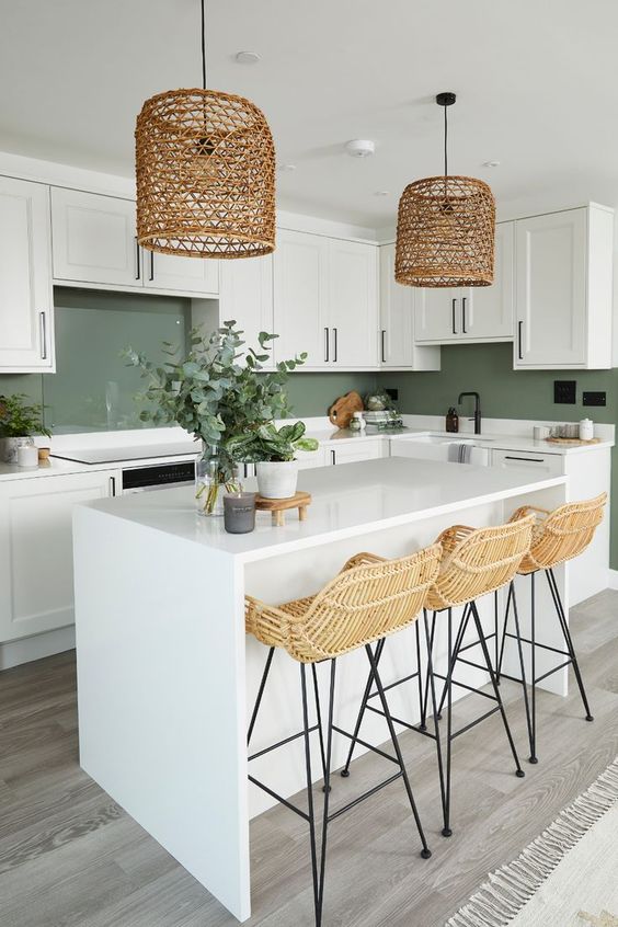 white kitchen with island and green backsplash