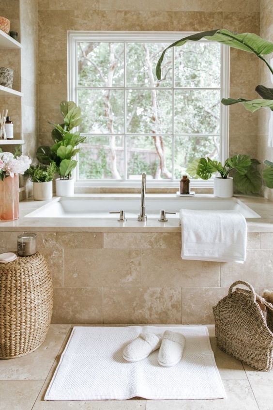 beige bathroo with large french window and plants